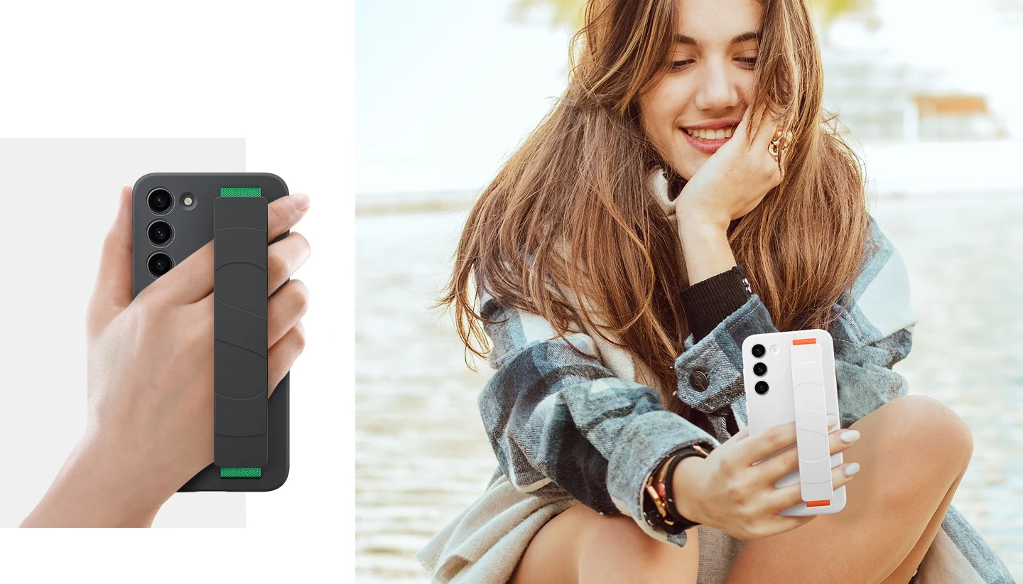 Рука крепко держит Galaxy S23+ с помощью ремешка. Рядом улыбающаяся женщина держит свой телефон с помощью силиконового чехла с ремешком.