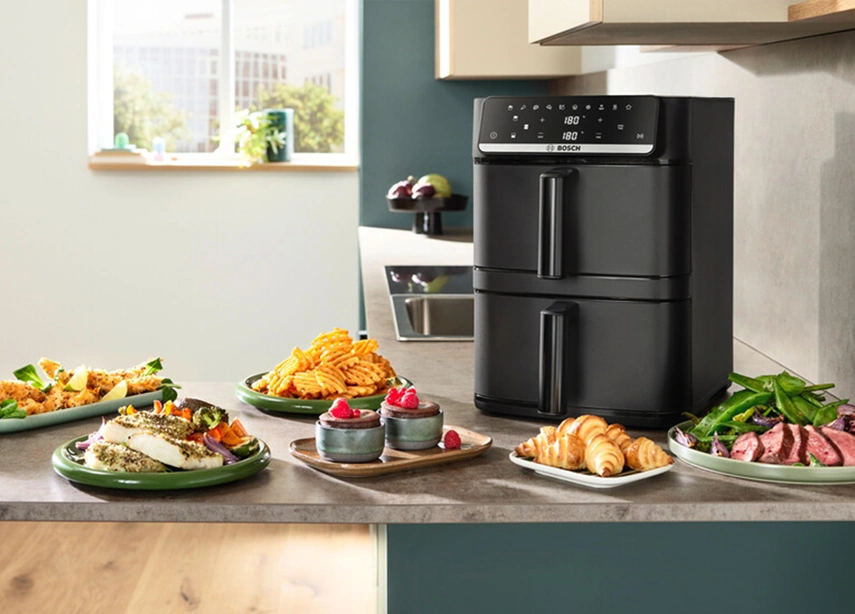 Мультипечь Bosch Серия 6 MAFD661B4 на кухонной столешнице с блюдами