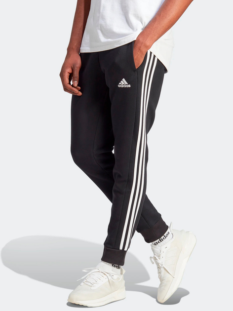 Spodnie dresowe męskie ocieplane adidas Fleece 3-Stripes Tapered Cuff IB4030 M Czarne (4066762309986) - obraz 1