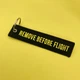 Брелок Remove Before Flight чорний з жовтими літерами - зображення 1