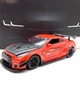 Машинка металева Авто Експерт Nissan Gtr 1:24 світло/звук Червона (GT-1502) - зображення 1