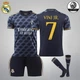 Комплект футбольная детская форма Lion SPORT Real Madrid VINI JN. (ВИнисиус Жуниор) 7, с гетрами (размер 34-38), размер 20 размер, рост 115-125 см, черный с оранжевым - изображение 1
