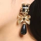 Сережки-кліпси “Black Orchid” масивні золотисті стиль вінтаж бант 8161 - зображення 2