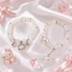 Парные браслеты Hello Kitty белый и серебристый с бусинами 8 мм на резинке, акрил + бижутерный сплав - изображение 1
