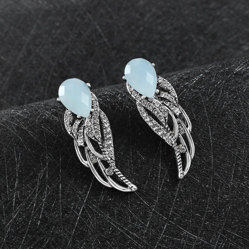

Серьги женские (бижутерия) крылья ангела Oxa с голубым камнем серебристые